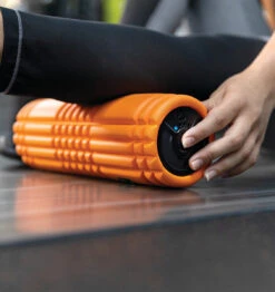 TriggerPoint GRID VIBE Plus Vibrating Foam Roller - 12" - Orange -Fitness Supplies Store TriggerPoint Grid Vibe Plus Vibrating Foam Roller Lifestyle 1
